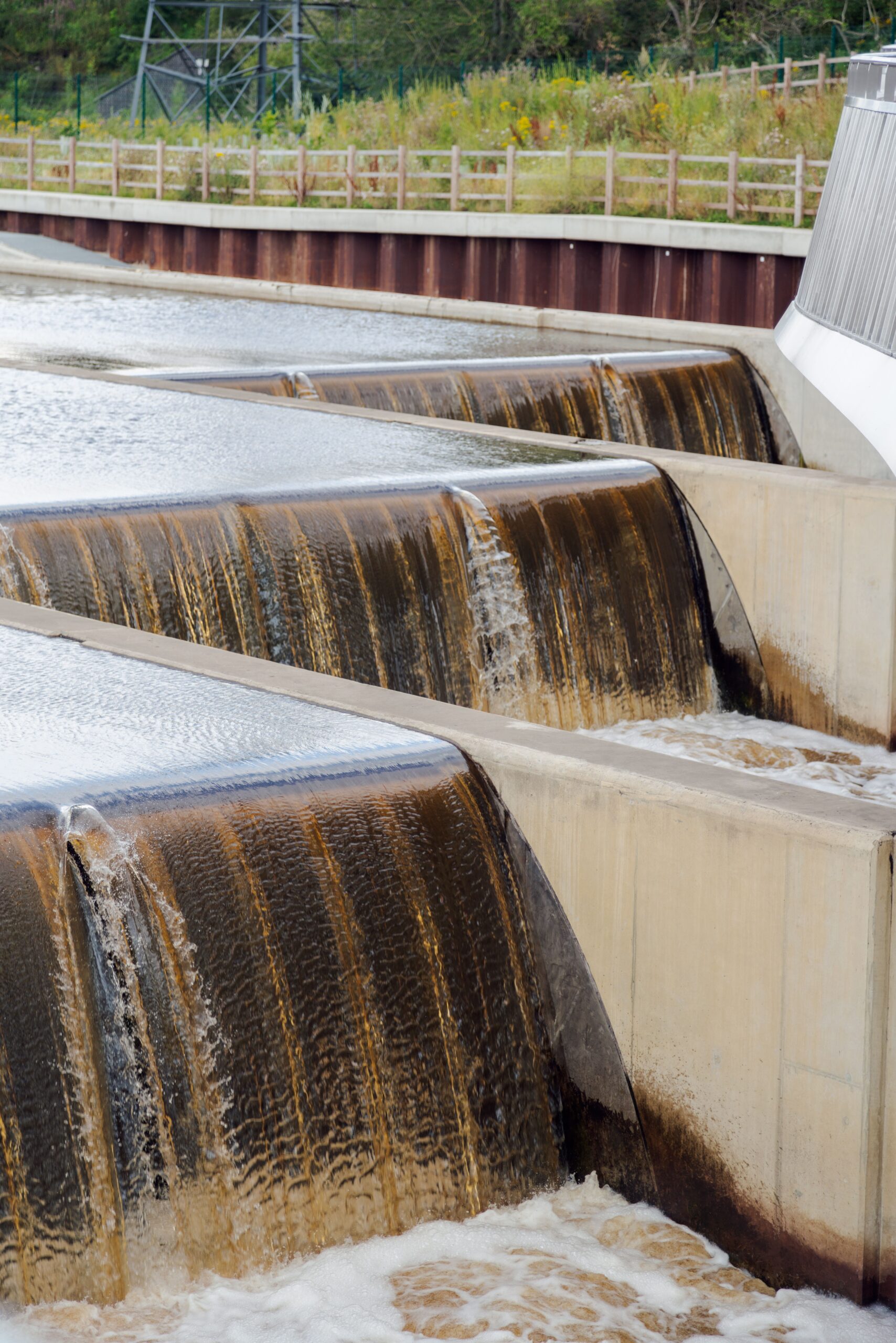 A weir with flowing water showcasing modern engineering outdoors.
